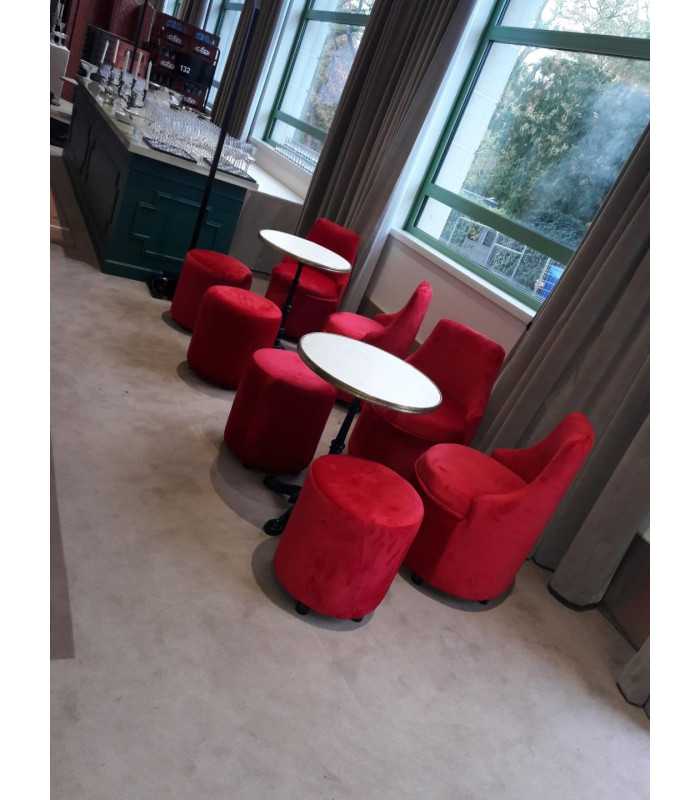 Red velvet barrel chairs and round poufs around marble bistro tables near a bar, rental by 126 Events