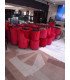 Red velvet barrel chairs and poufs grouped before setup in a reception hall, delivered by 126 Events