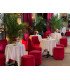 Red velvet barrel chairs and poufs around white-clothed tables, reception lounge furnished by 126 Events