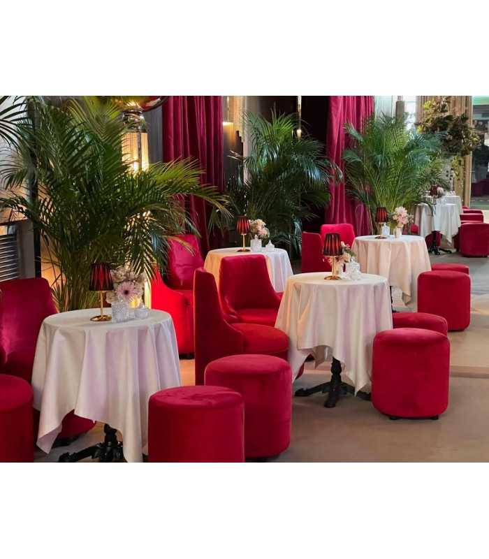 Red velvet barrel chairs and poufs around white-clothed tables, reception lounge furnished by 126 Events