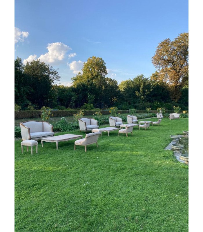 Louis XV style ceruse coffee table 120 x 60 cm in a garden with stools and white sofa