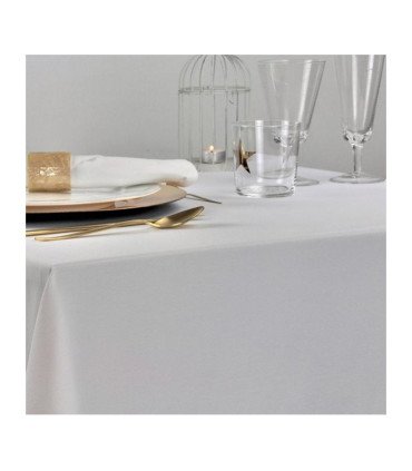 White tablecloth in flame-retardant polyester set on a table with plates and glasses.