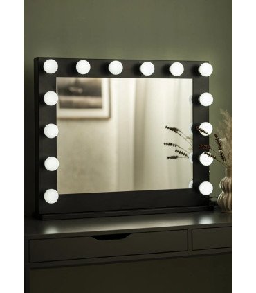 White LED makeup mirror on a light wood console table in an event dressing room