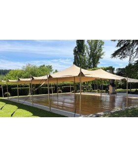 150 m² sand-colored nomadic tent set up on a wooden deck in a garden