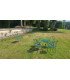 Round, folding garden table, Ø 77 cm, made of green Floréal metal, with matching chairs in a garden