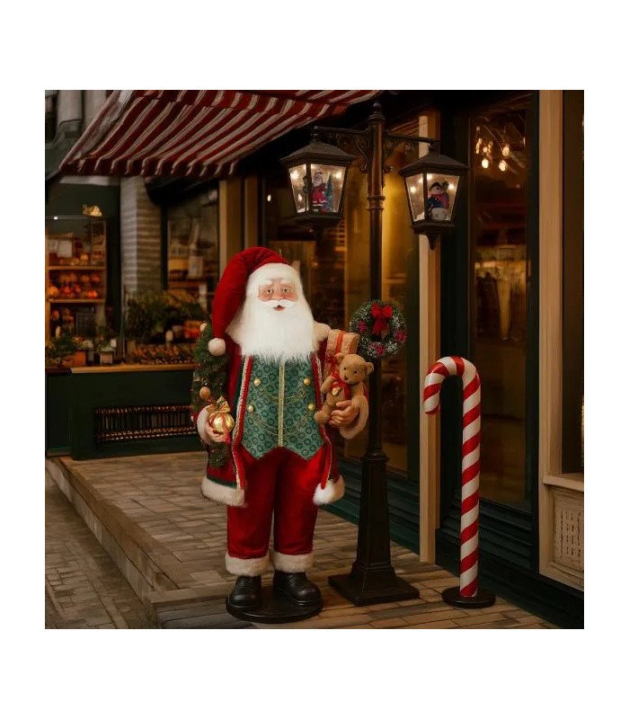 Sucre d'orge avec support H 120 cm intégré dans un décor de Noël avec figurine de Père Noël.