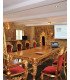 Two thrones in gilded wood and red velvet around a large gilded table in a reception room