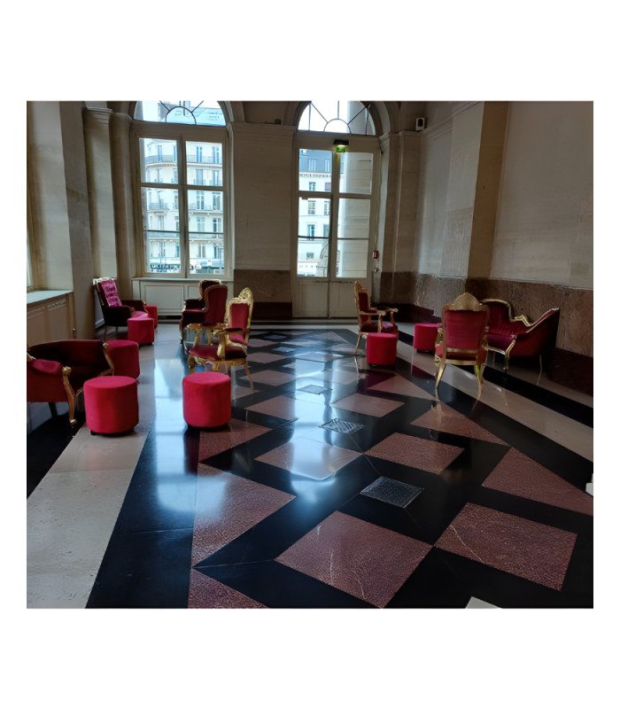 Golden and red baroque-style armchair in carved wood and red velvet installed in a reception room in Paris