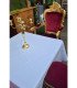 Golden and red baroque-style armchair arranged around a table covered with a tablecloth and a candlestick for a reception