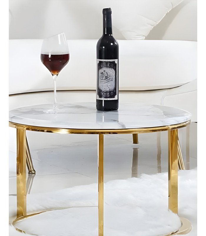 Gold-toned coffee table with marble-effect top, paired with a sofa and rug.