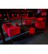 Fringed red velvet pouf with a Chesterfield sofa and armchairs, lounge furniture from Location Mobilier Paris