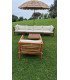 Adjustable bamboo parasol set up in a garden with a bamboo sofa and armchair in an outdoor lounge area