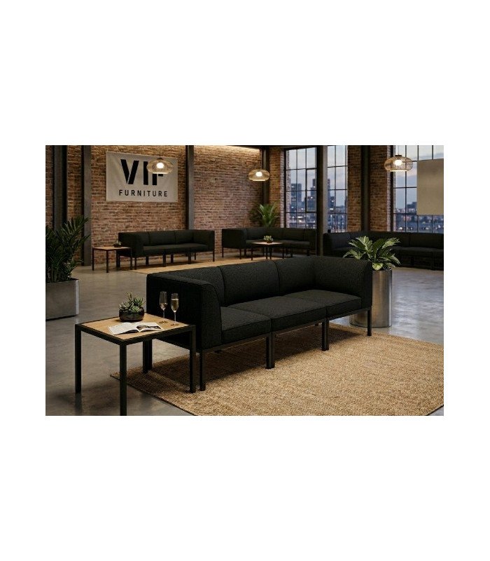 Canapé noir modulable 3 pièces installé dans un salon d’appartement avec espace lounge aménagé