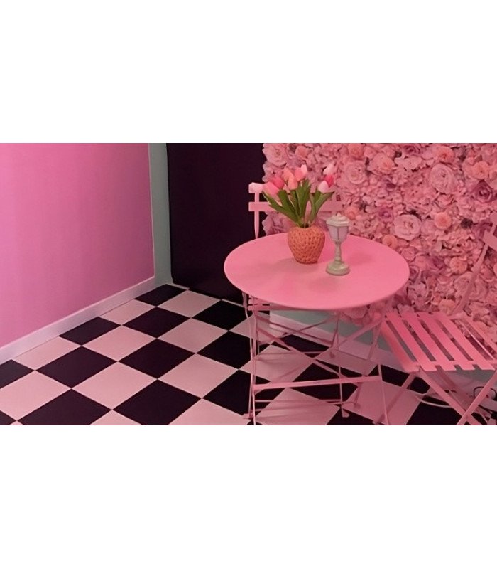 Black-and-white checkered vinyl flooring with bistro tables and metal chairs for an event setup