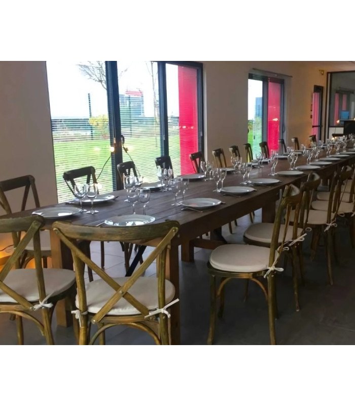 Arrangement of 213 cm wooden folding tables forming a large table with wooden chairs