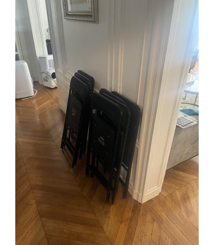 Black folding chair with inter-row connecting bar