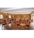 Louise gold and red velvet chairs in a stone-walled reception room, seated cocktail setup, baroque furniture rental